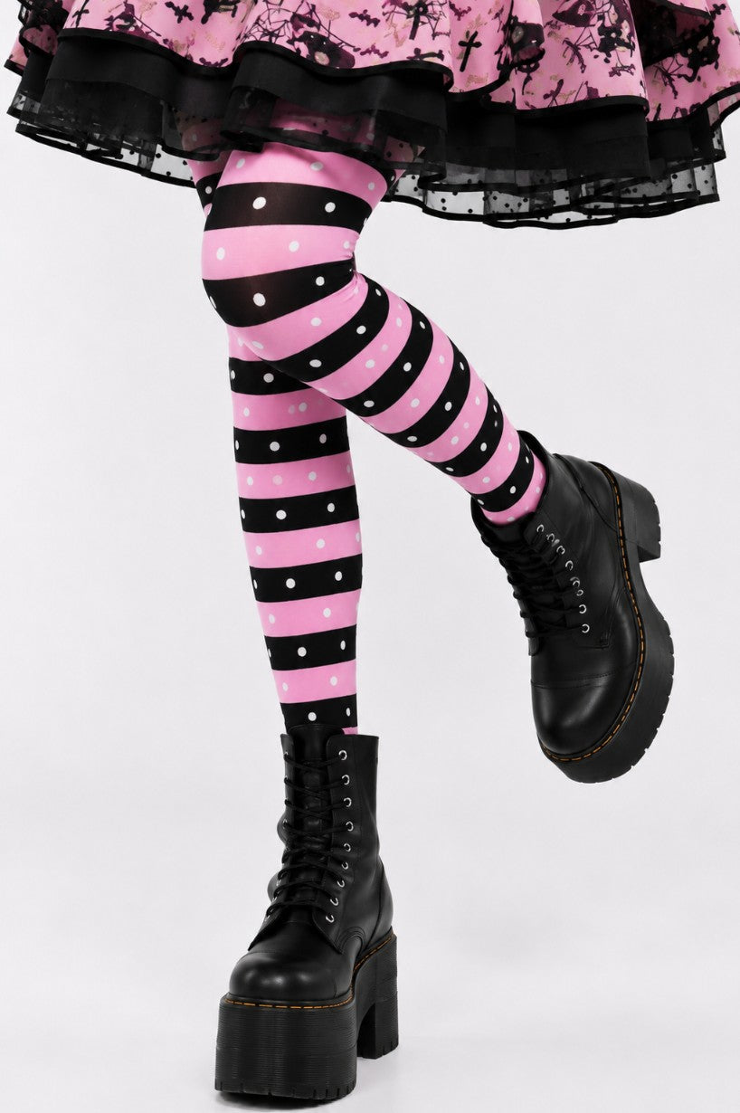 Model posing in bubblegum brat stockings and pink black outfit for a kawaii goth brat punk photoshoot