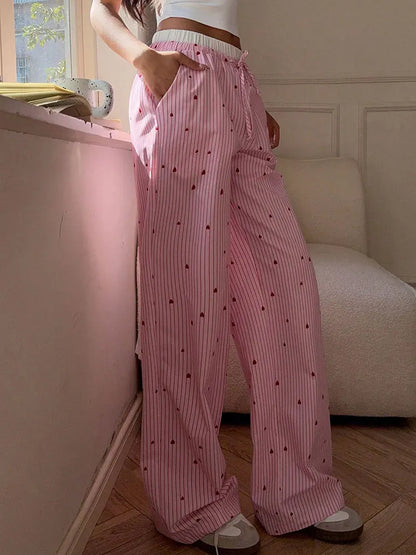 Candycore pastel pink striped lace pants with romantic heart lace-up, ideal for soft baddie and dollcore looks