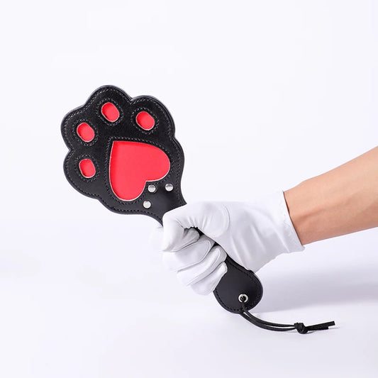 Paw-shaped spanking paddle in red and black for cute baddie DDLG play vibes