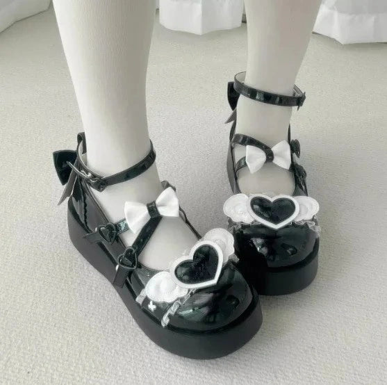 Deep black Cherub Heart Cutie Platforms with soft heart centerpiece and ethereal wing details, ideal for DDLG or gothic lolita style.