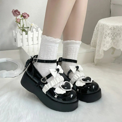 Deep black Cherub Heart Cutie Platforms with ethereal wing details and sweet heart accent for gothic lolita or ABDL style.