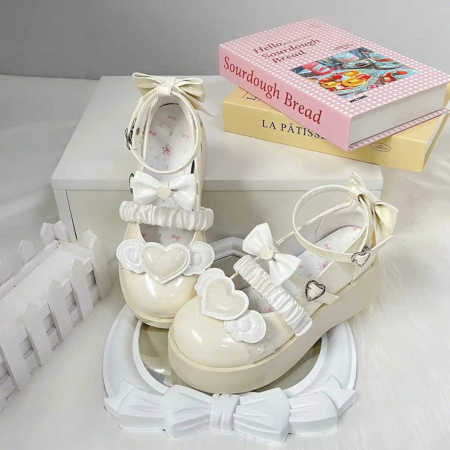Pastel yellow Cherub Heart Cutie Platforms with dainty platform lift, fluttery wings, and heart centerpiece for kawaii style.