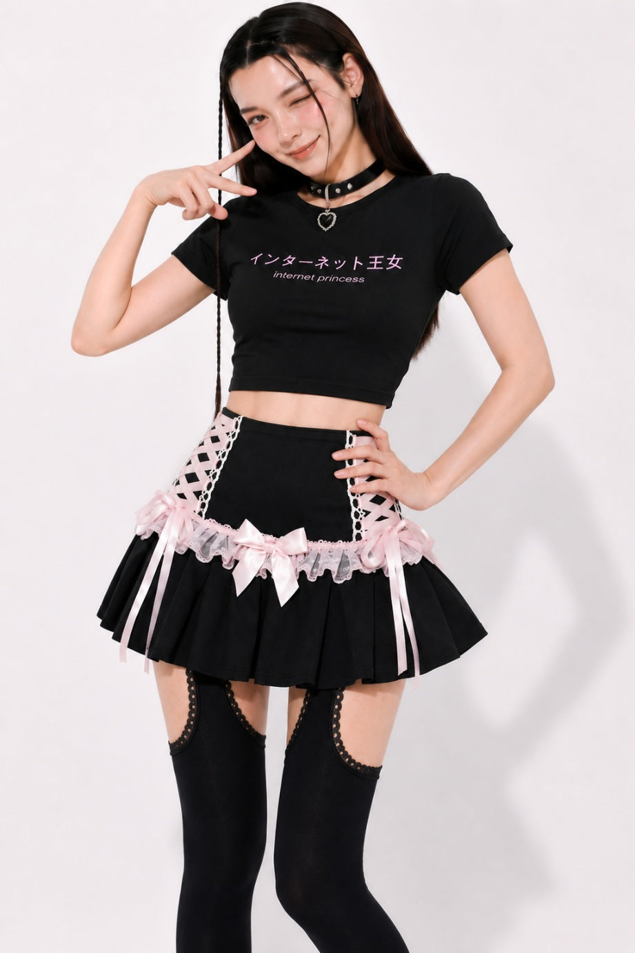 Lace up side panel detail with crisscross pink ribbon on black coquette skirt