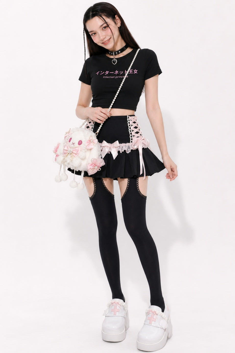 Model wearing black coquette lace up pleated mini skirt, DDLGirl Jirai Kei style
