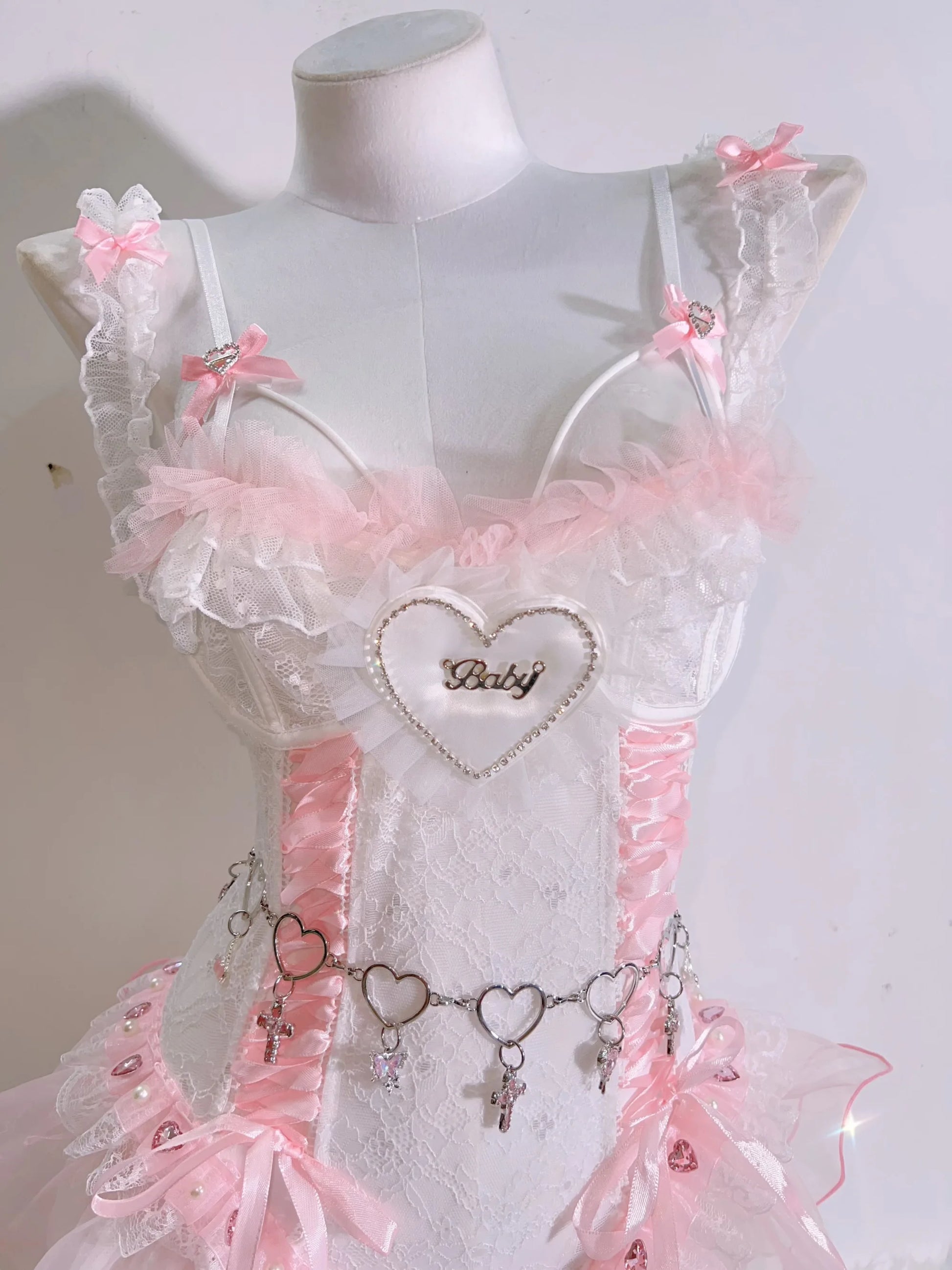 Corset set with pink lace and baby script text, combining cheeky charm and soft glam for babygirl and ABDL expression