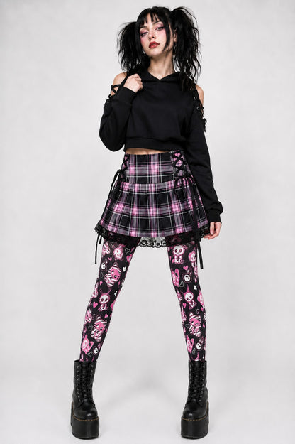 Model styling creepy kawaii skeleton bunny tights with a plaid skirt for alt Halloween outfit