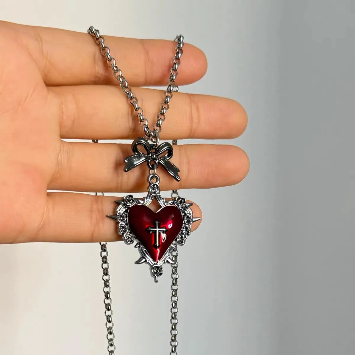Deep red thornheart necklace with gothic roses and ribbon bow, ideal for DDLG and soft goth fashion lovers