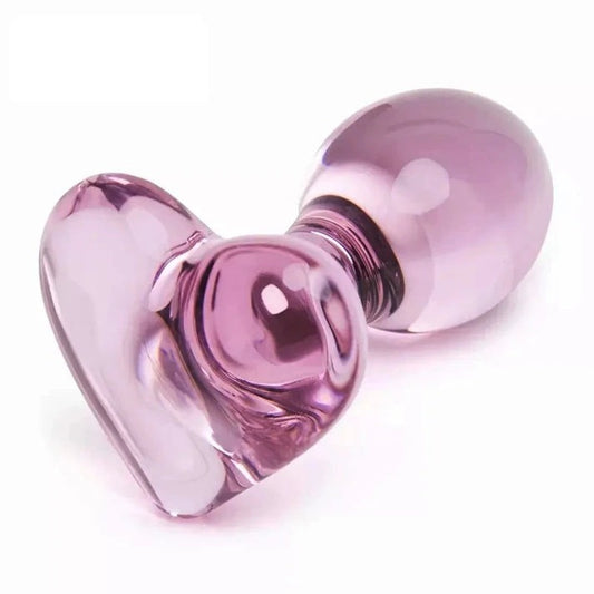 Smooth glass butt plug with pink heart base, beginner-friendly size, and polished crystal finish.