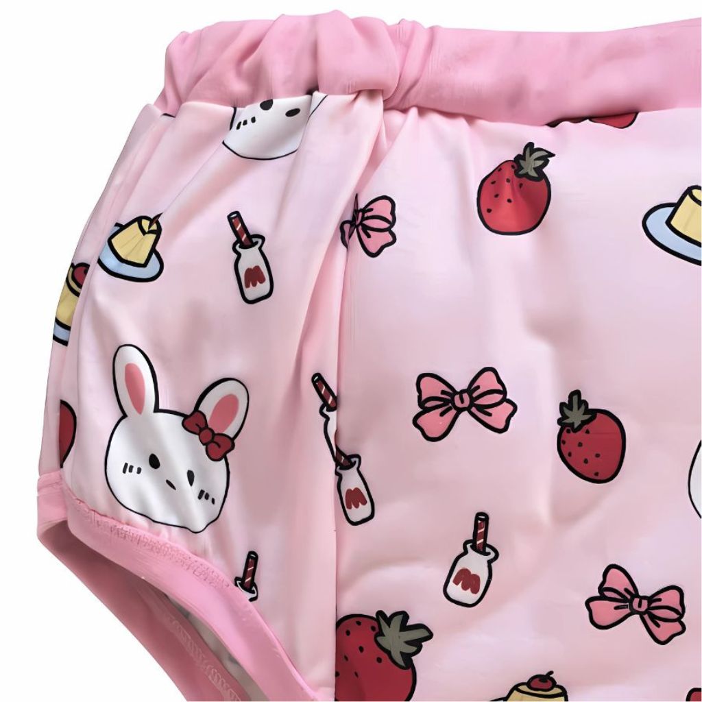 Pink waterproof PUL diaper cover with playful bunny and cake illustrations, cozy and cute for DDLG or littlespace use