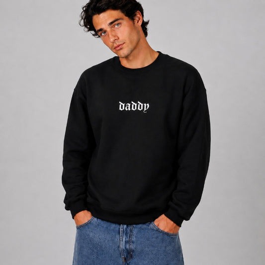 Model wearing black Daddy Energy sweater with bold classic font print