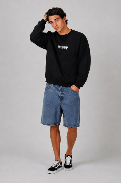 Man wearing black Daddy Energy sweater in a casual cozy lifestyle shot
