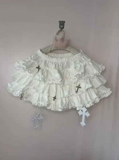 White gothic lolita skirt with standout cross appliqués, frilly layers, and comfy waistband for DDLG ABDL fashion