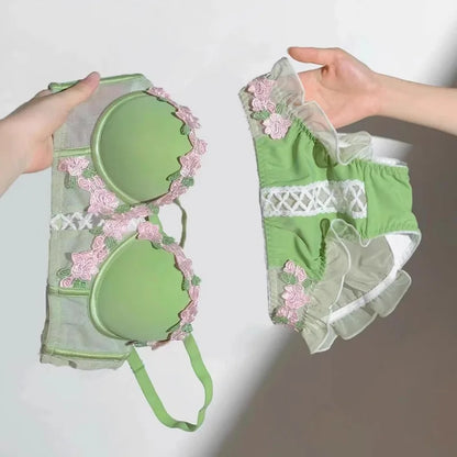 Green garden-inspired bustier and lace-up panty set with embroidered flowers and ruffle details for DDLG ABDL kawaii outfits