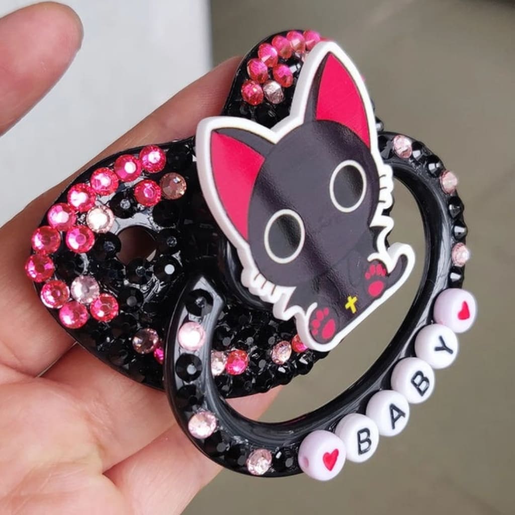 Cozy and playful Midnight Meow Pacifier with black cat design and gentle silicone nipple for comforting adult use and regression time.