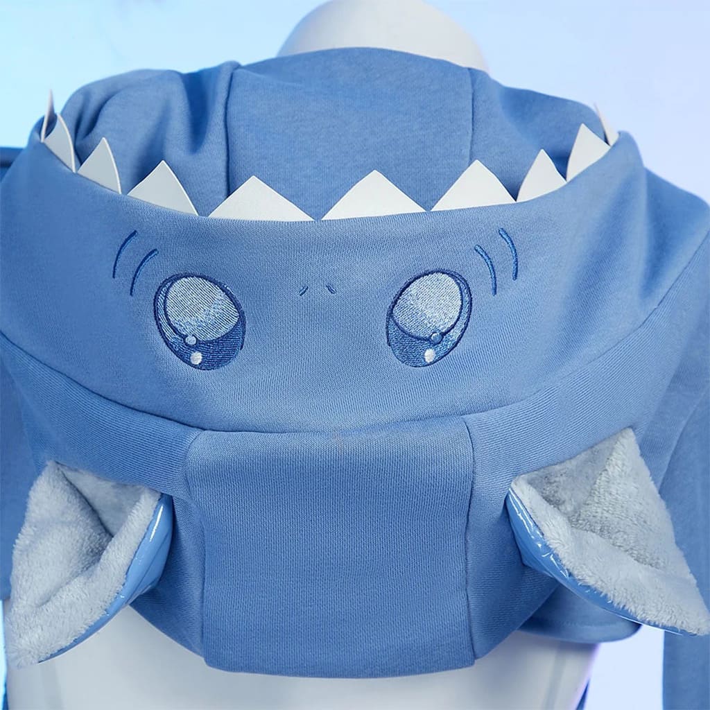 Close-up of Sweet Shark Bite hoodie with embroidered shark eyes and tooth detail edging in soft blue fabric