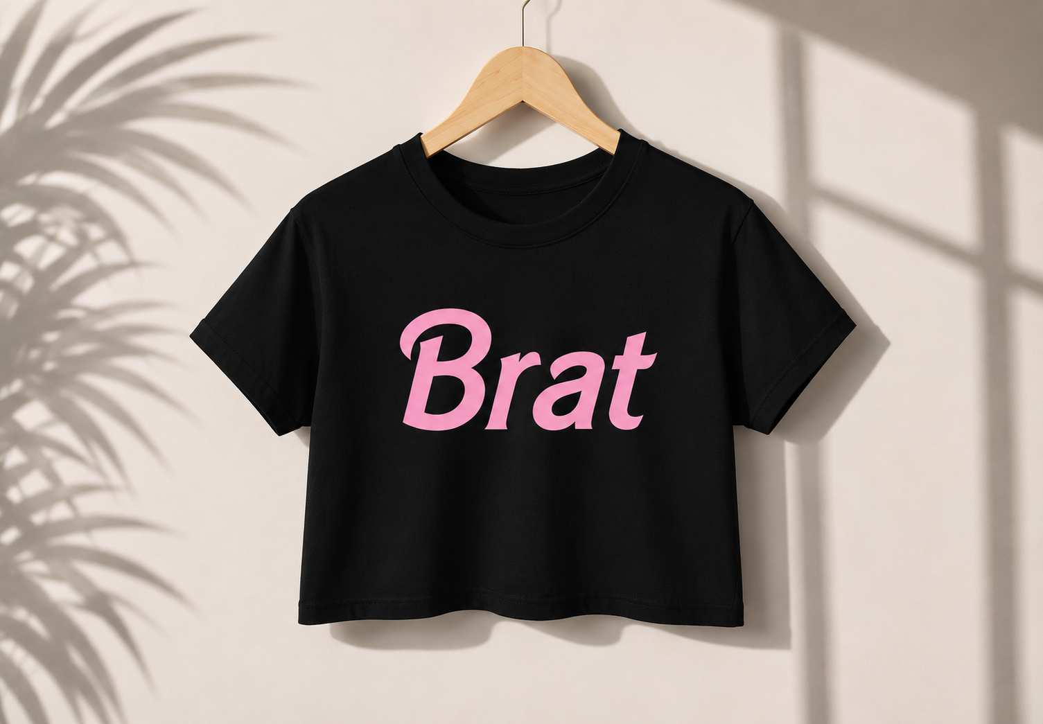 Flat lay of DDLGirl Brat Energy Crop Top showing pink Brat graphic and white crop design for DDLG ABDL kawaii cutecore bratcore gifting