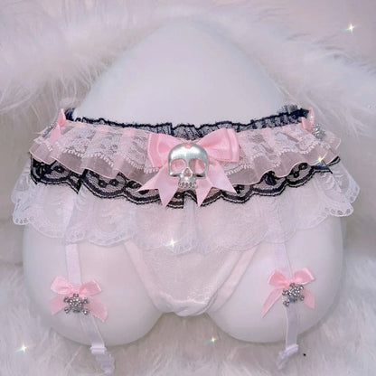 Black lace thong and garter set with skull accents, blending cute Harajuku and alt lingerie styles