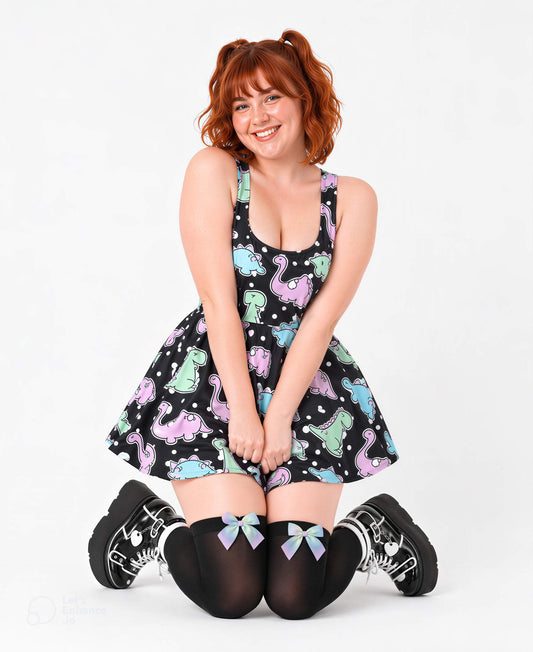 Model seated wearing Dino Party pastel polka dot dress, ABDL DDLG style