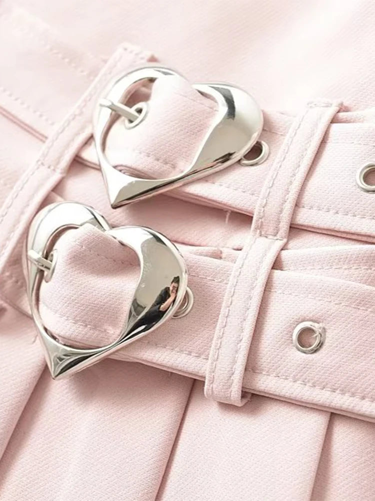 Double heart buckle detail on layered waistband of pleated mini skirt