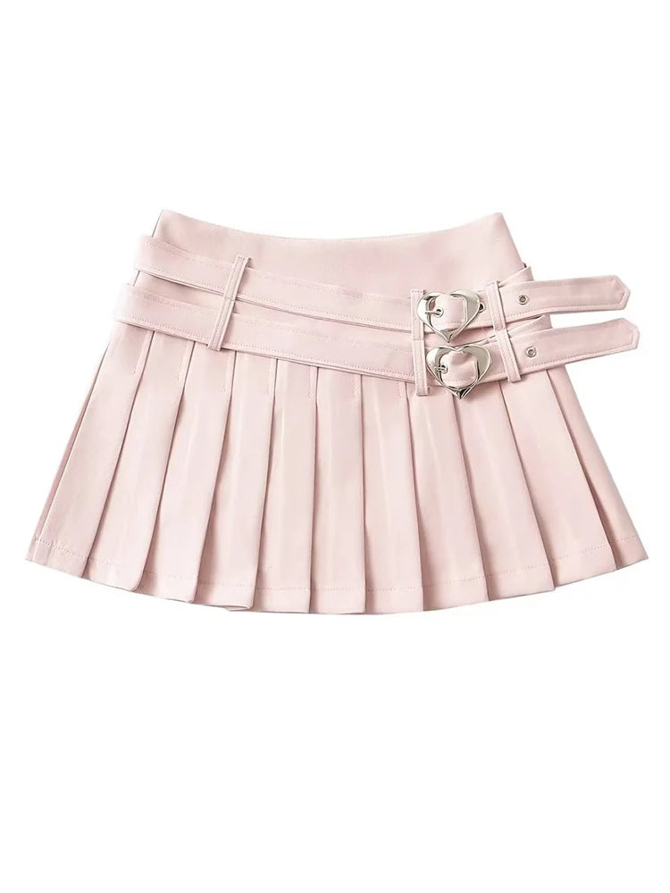 Flat lay of double heart buckle pleated mini skirt in pink, black, and white