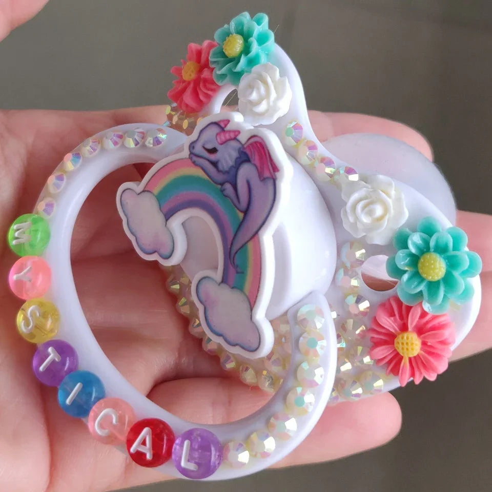 Eco-friendly BPA-free pacifier with dragon and rainbow design for magical little moments