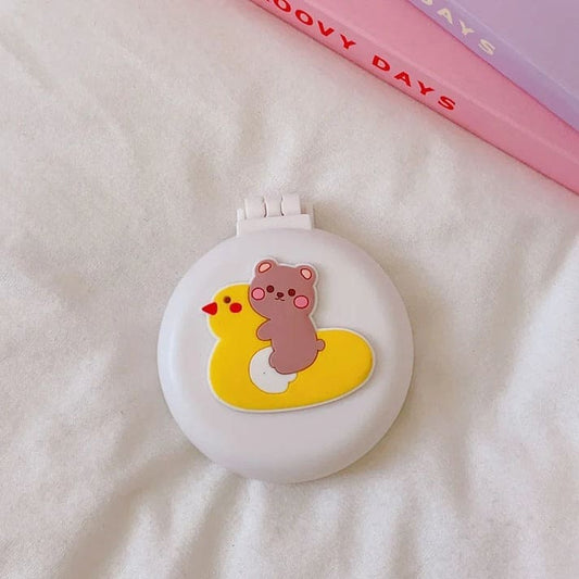 Compact brush and mirror set with kawaii bear on yellow duck design, foldable and perfect for littles or on-the-go grooming.