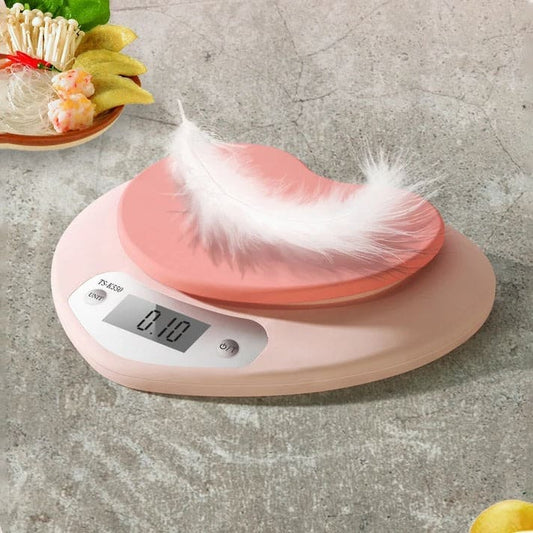 Heart-shaped digital scale in pink with easy-to-read LCD display, perfect for home kitchens and cafes