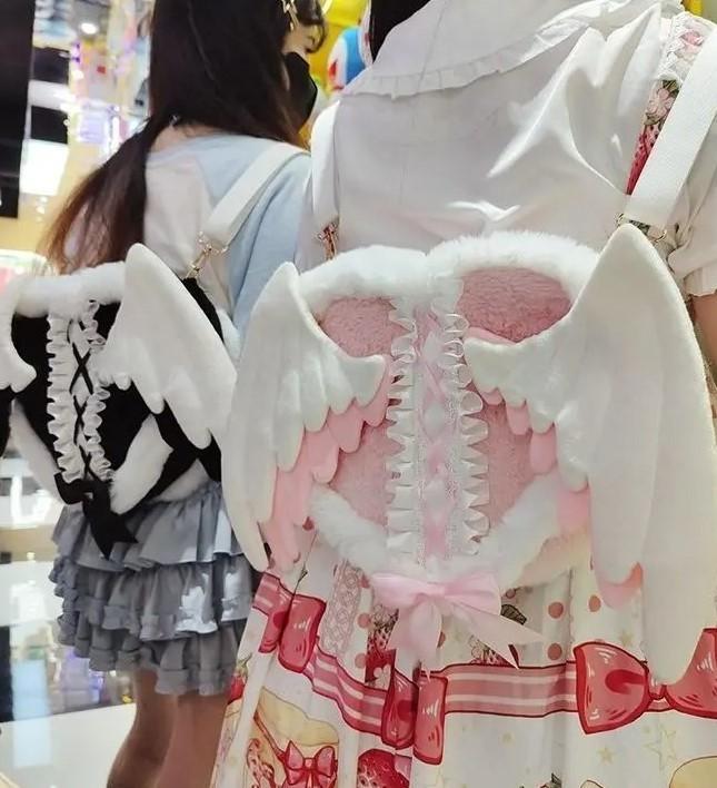 Kawaii heavenly angel wings plush backpack in pink & white for soft girl, lolita, and cutecore fashion