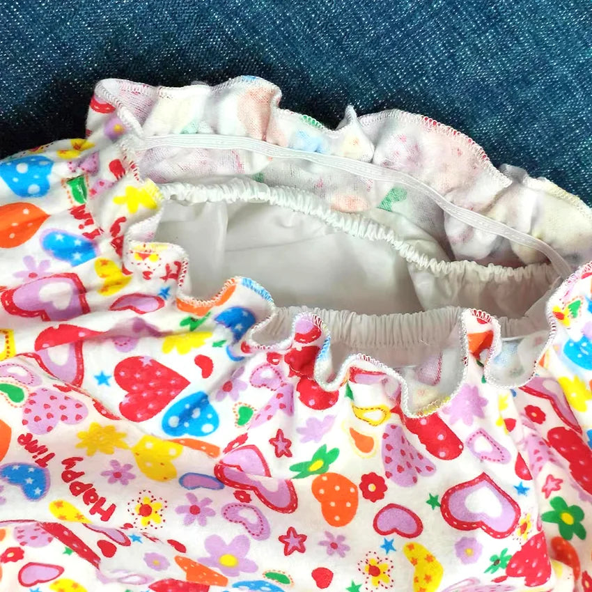 Kawaii pink Love Bubble Rainbow ABDL shorts with heart print, PVC-lined and elastic waist for comfort