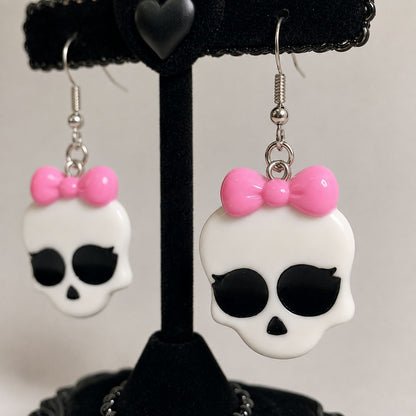 Bright pink bow detail on kawaii monster babygirl skull earrings