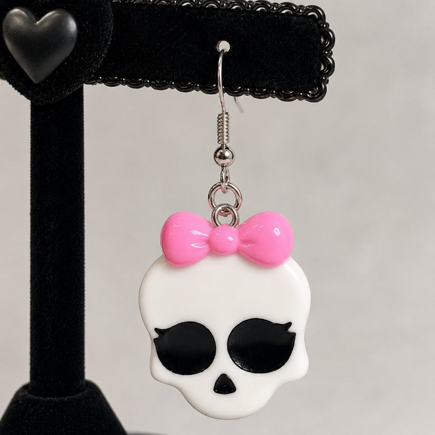 Flat lay of kawaii monster babygirl bow earrings, DDLGirl monster girl style