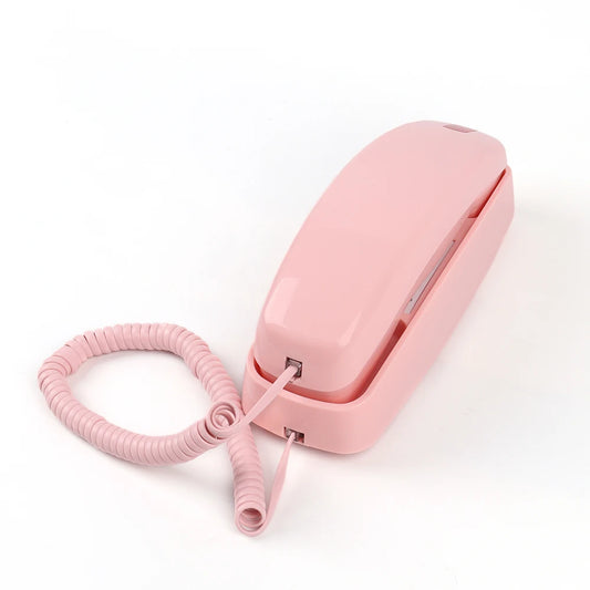 Kawaii retro pink corded landline phone with big buttons and cute design in angled view