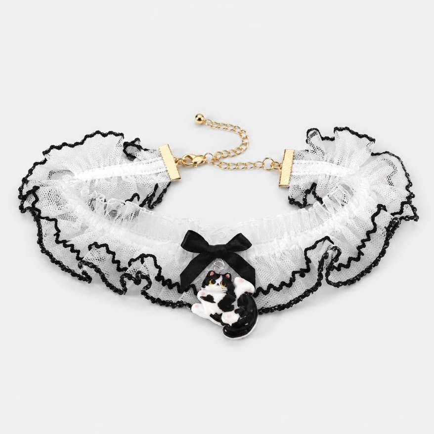 Close up of kitty charm and bow on ruffle lace choker