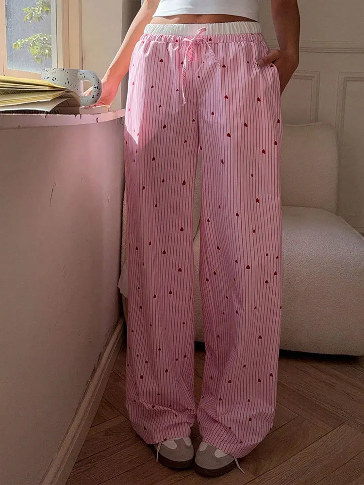 Slim-fit pink striped pants with lace-up heart sides, perfect for DDLG and kawaii bratty vibes