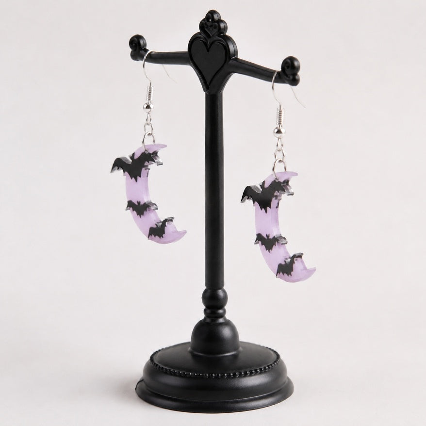 Side view of lavender moon bat dangle earrings showing flat design