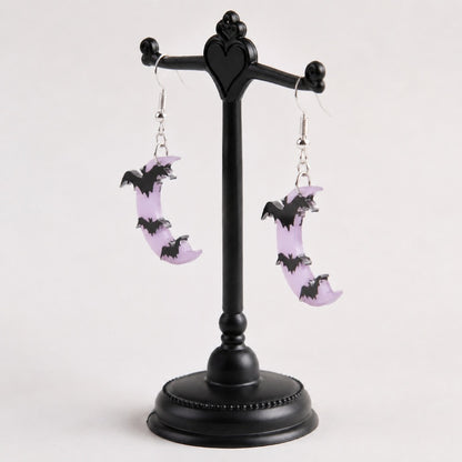 Side view of lavender moon bat dangle earrings showing flat design