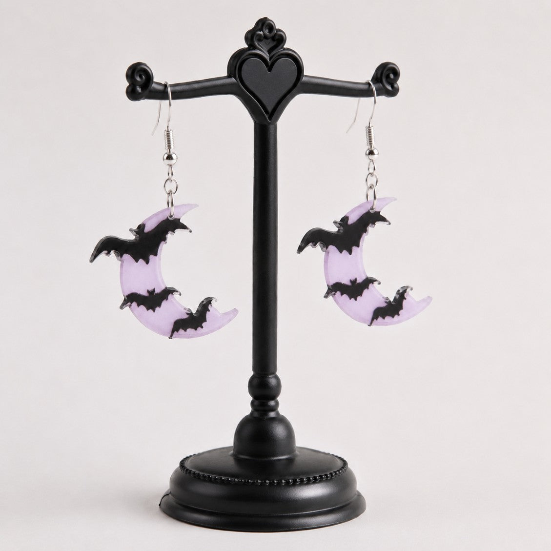 Model wearing lavender moon bat dangle earrings, DDLGirl pastel goth style