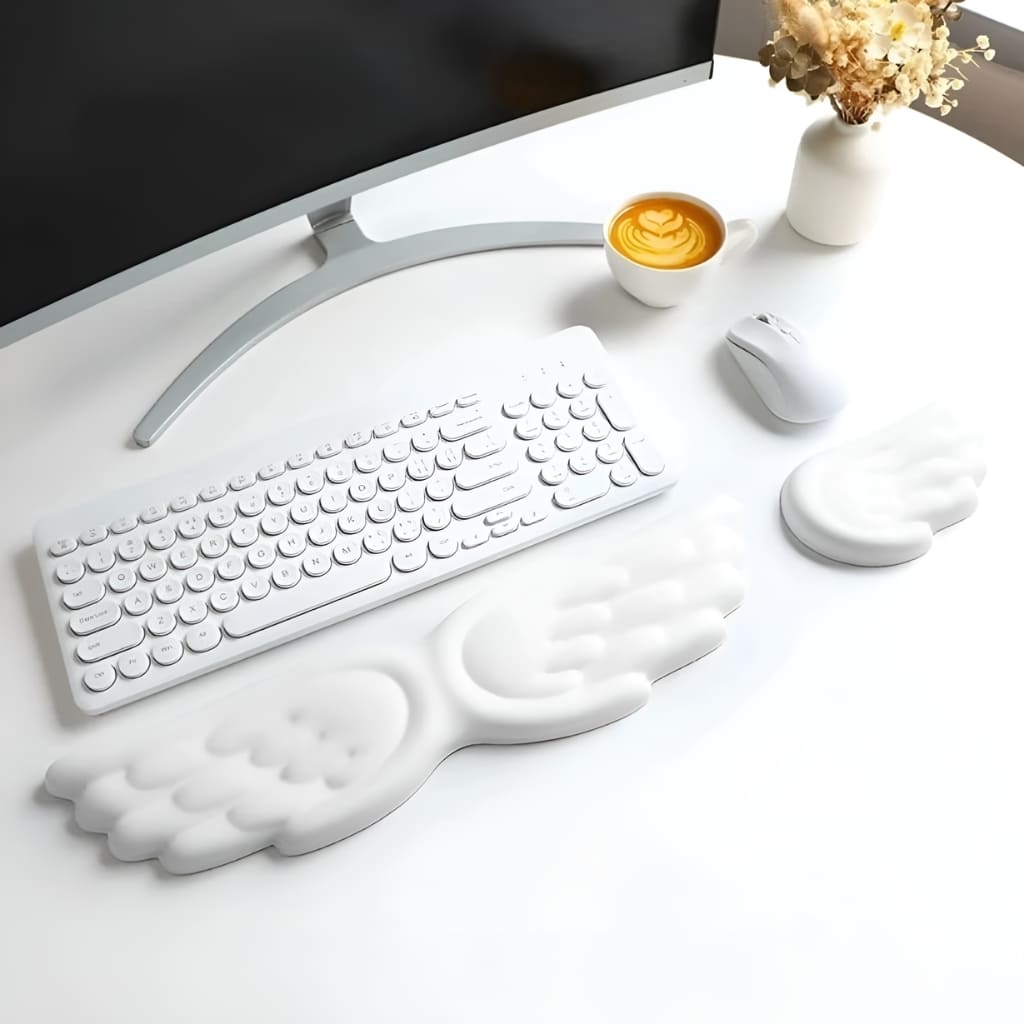 Cute pink keyboard wrist rest shaped like angel wings, designed for comfort during typing, gaming, or studying.