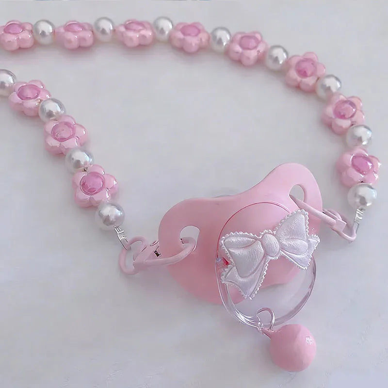 Detail of bell on handle of Little Baby Bloom Bell Pacifier, playful kawaii accessory for soft girl vibes
