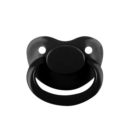 Flatlay of Little Fang Spooky Baby Pacifier styled with gothic Halloween accessories