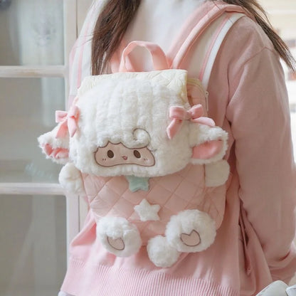 Close up of embroidered lamb face with rosy cheeks and floppy ears on plush backpack