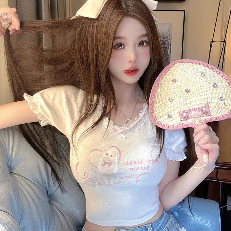 Close-up of My Little Kitty Crop Top in white, detailed kitty graphic, lace neckline, cutebaddie & ABDL accessory