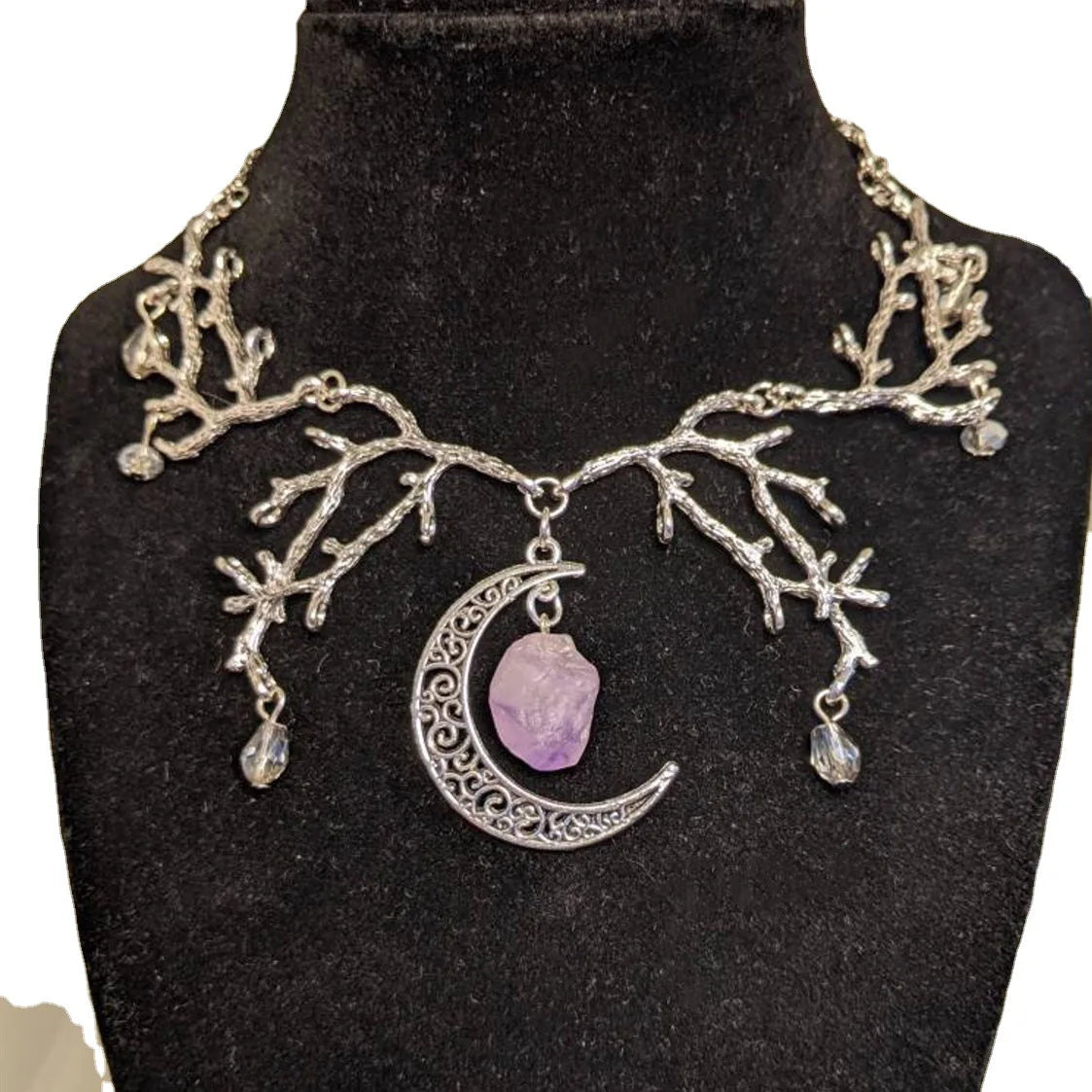 Close-up of Mystic Amethyst Vine Necklace showing handcrafted tree branch metalwork and amethyst crystals