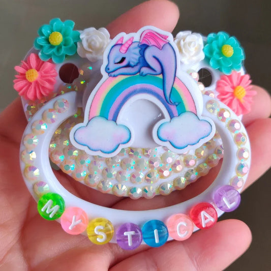 Mystic rainbow dragon pacifier with floral accents for babycore and kawaii vibes