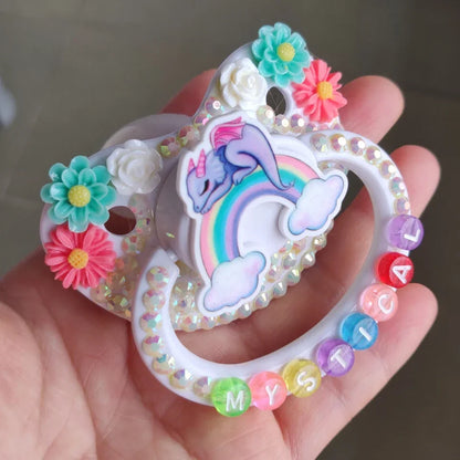 Pastel dragon pacifier with mystical rainbow letters, perfect for soft babycore aesthetics