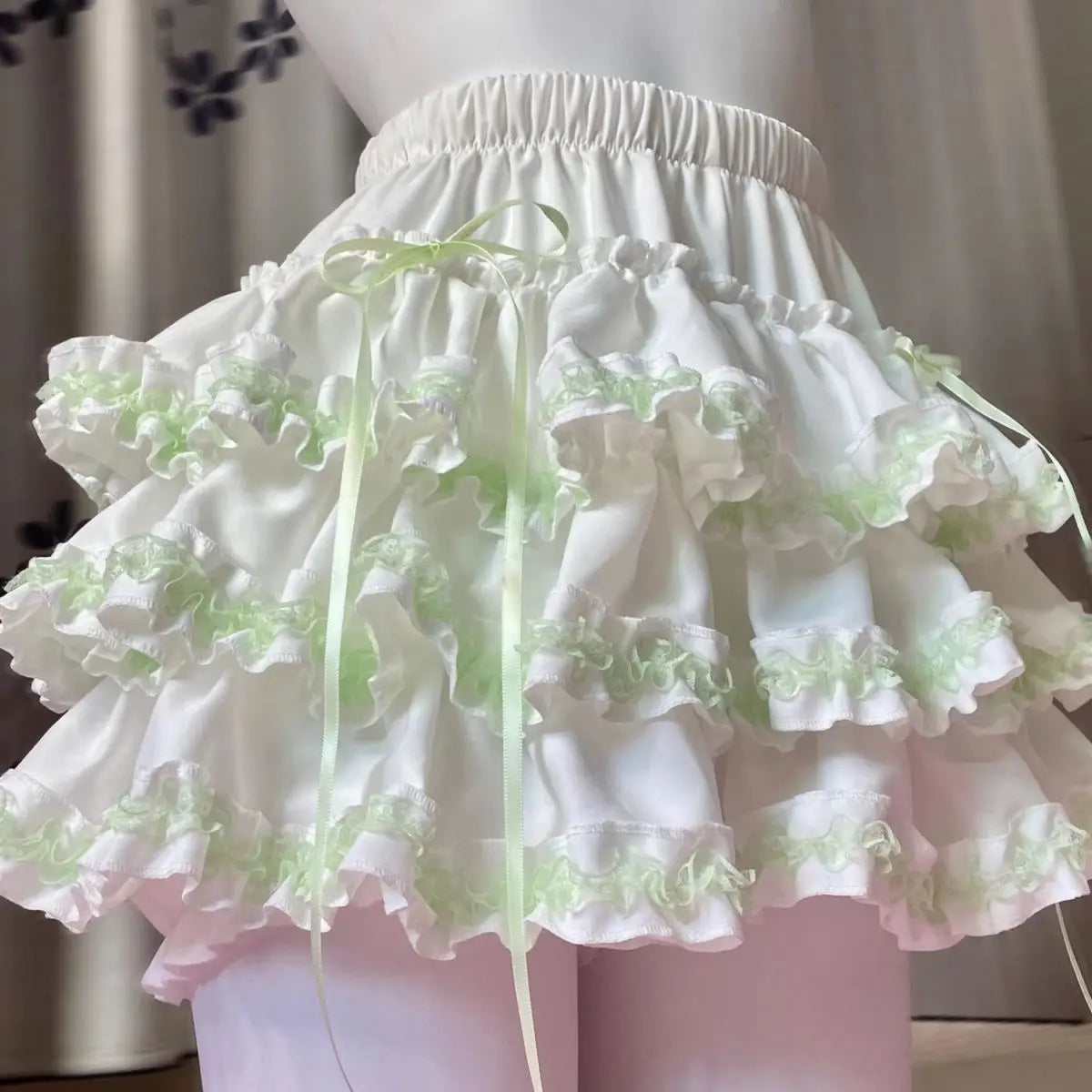 Pastel green whipped cream Lolita ruffle skirt with fluffy layered frills and lace details for kawaii, soft girl, DDLG, ABDL, and cutecore outfits