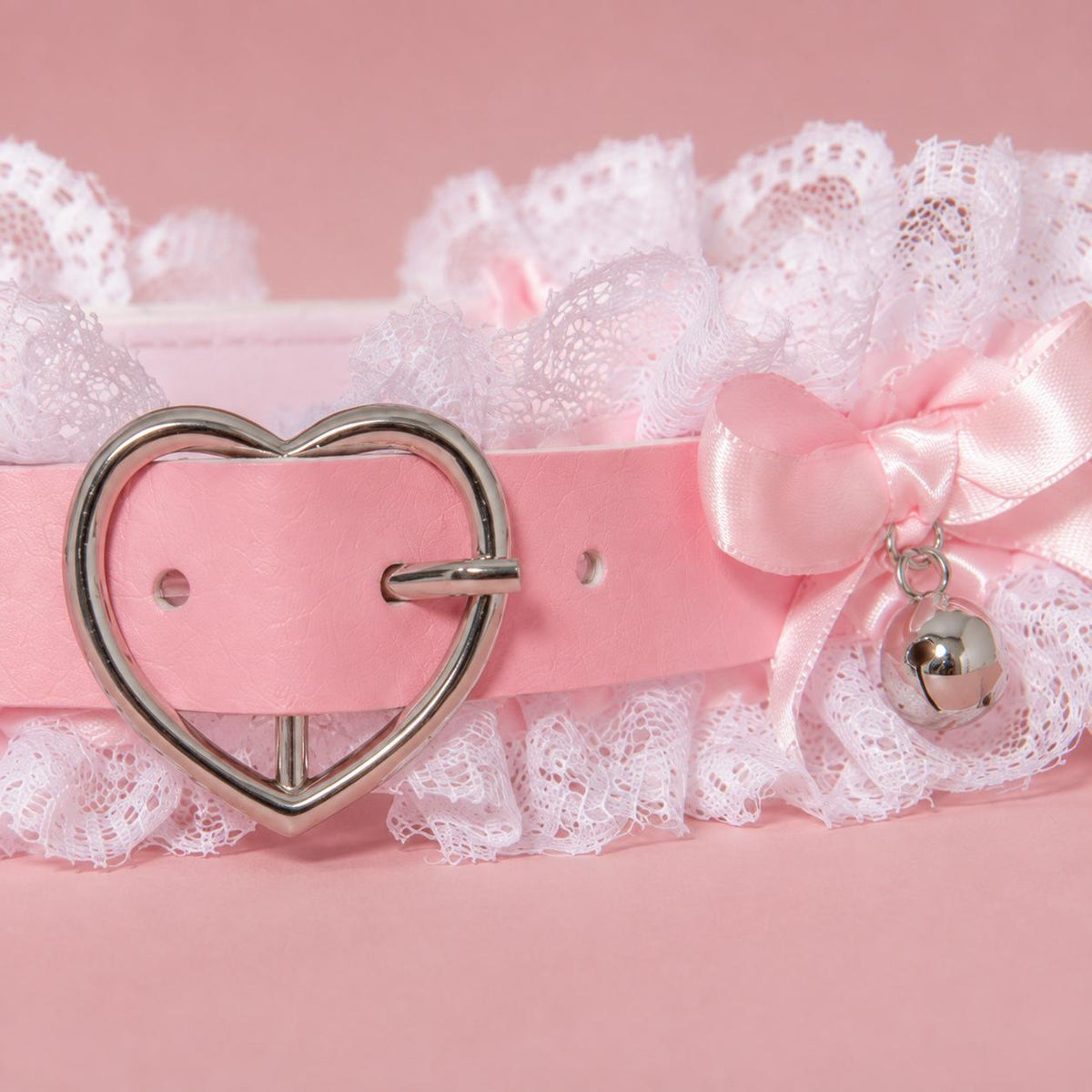 Tiny dangling bell detail beneath bows on pink angel clouds choker