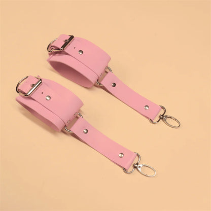 Playful pink wrist-to-thigh harness made from soft faux leather, perfect for roleplay and sexy aesthetics
