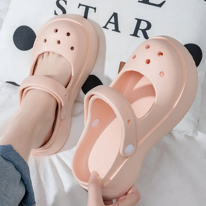 Close-up of pink summer platform slides with thick sole and cute soft girl style