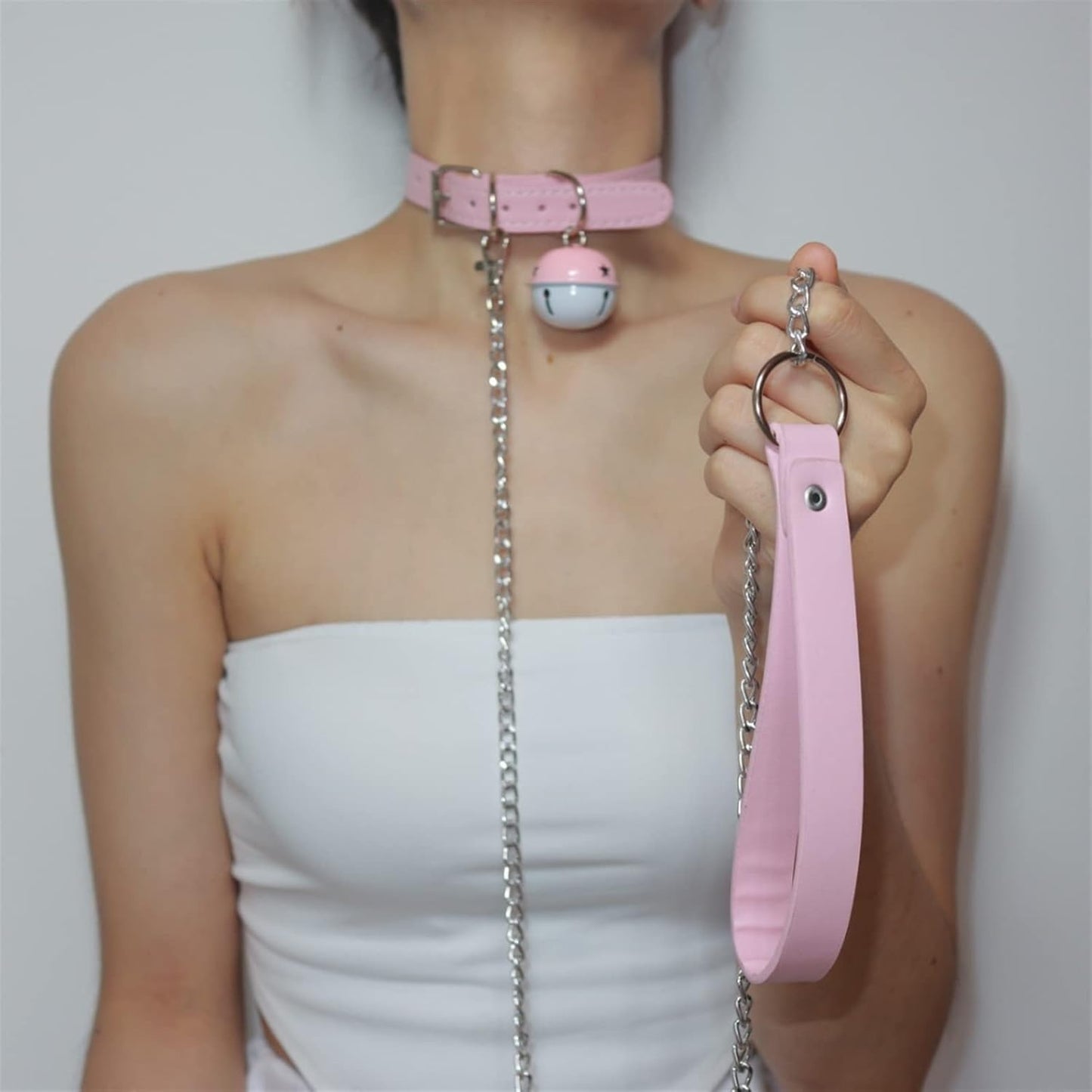 Closeup of flirty bell detail on Pink Temptation Choker for DDLG kawaii cutecore babygirl little space and sweet roleplay vibes